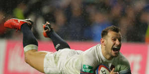 England's Danny Care smiles as he goes over the line for England's fourth try.