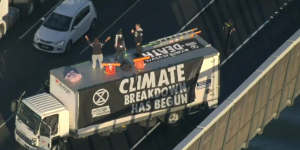 Climate protesters on the roof of the truck.