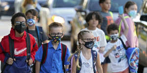 Children arrive at school wearing masks in Florida,US.
