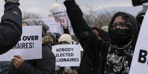 People protest during a rally against Elon Musk outside the US Department of Labour in Washington.