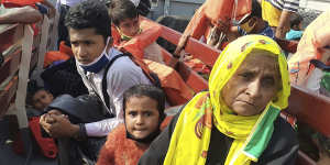 Rohingya refugees board a ship as they are ferried to Bhashan Char.