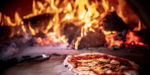 Feeling hot,hot hot:Grossi's simple margherita pizza being cooked in a wood-fired oven.