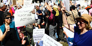 Supporters of Palestine Action hold placards in Parliament Square,London.