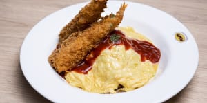 Omurice with tempura,tomato sauce and melted cheese.