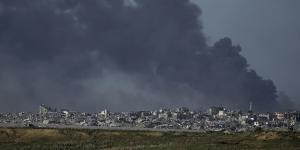 Smoke rises following an Israeli bombardment in the Gaza Strip,as seen from southern Israel on December 26.