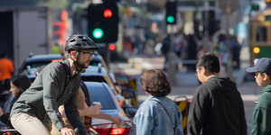 A cyclist in Flinders Street,where a planned separated bike lane is also on hold. 