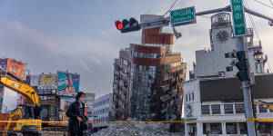 A person walks past an area cordoned off following the earthquake in Hualien,Taiwan.