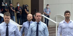 Constable Zachary Rolfe (centre) leaving court on the first day of his trial for the murder of 19-year-old Kumanjayi Walker. 