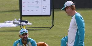 McDonald (right) talks to Nathan Lyon during a training session in Pakistan.