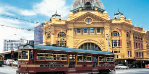 A W-Class tram saunters past Flinders St Station in Melbourne’s CBD.