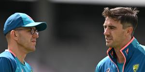 Australia captain Pat Cummins speaks with Todd Murphy during a nets session at Emirates Old Trafford on Monday.