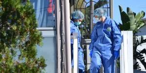 Forensic officers comb the Bent Street house on Monday.