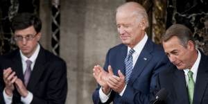 US Vice President Joseph Biden,centre,applauds as House Speaker John Boehner,right,greets Pope Francis as he arrives to speak to Congress in the House Chamber at the US Capitol.