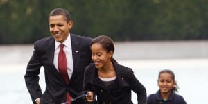 Malia Obama runs with Bo,followed by President Barack Obama and Sasha Obama,on the South Lawn of the White House in Washington in 2009. Bo has died after a battle with cancer,the Obamas said on social media. 