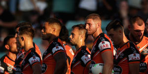 Tigers players look on after a Titans try.