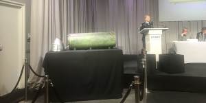 AFP commander Jennifer Hurst shows the missile that allegedly shot down MH17 at a press conference in the Netherlands.