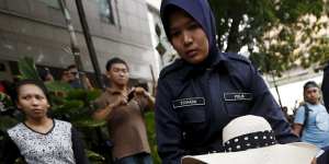 Police seize a demonstrator in Kuala Lumpur.