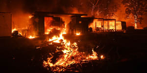 Firefighter overwhelmed by flames at bushfire in Orangeville,5 December 2019. Photo Nick Moir