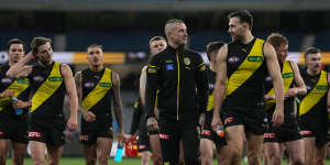 Injured Dustin Martin leaves the field with Noah Balta and their Richmond teammates.