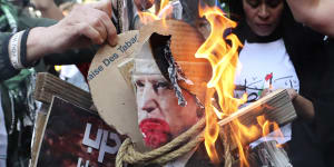Protesters burn pictures of US President Joe Biden at the Palestinian refugee camp of Ein el-Hilweh in south Lebanon.