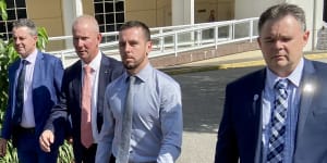 Zachary Rolfe (without jacket) leaving court flanked by NT Police Association president Paul McCue (right) and Police Federation of Australia president Ian Leavers (second from left).