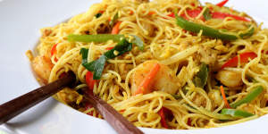 Curry powder gives Singapore noodles its signature golden colour.