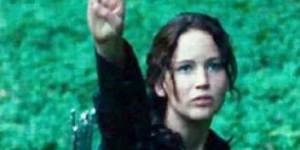 Hunger Games narrator Katniss Everdeen shows strength with the three-finger salute.