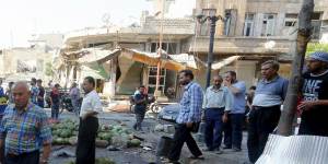 Residents gather at a market damaged by what activists said was an air strike by forces of Syria's President Bashar al-Assad on Tuesday.