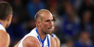 Ben Cunnington gets a handball away for the Kangaroos.