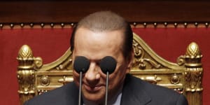 Berlusconi framed by microphones in the Italian Senate in 2010. 