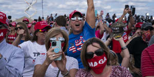 Supporters of President Donald Trump cheer as he arrives to speak at a campaign rally at Pitt-Greenville Airport in Greenville,NC. 