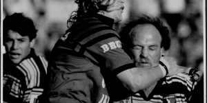 Wally Lewis is tackled during a game in August 1991.