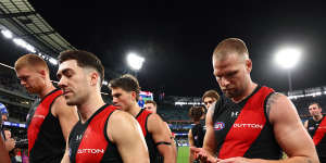 The Bombers look dejected as they leave the field following their loss.