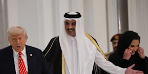 US President Donald Trump and Emir of Qatar Tamim bin Hamad Al Thani arrive for a state dinner at the Lusail Palace on in Doha,Qatar.