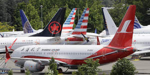 Dozens of grounded Boeing 737 MAX planes crowd a parking area near its factory in Seattle.