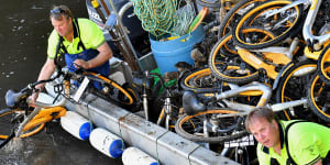 Contractors for oBike collect bicycles from Melbourne’s Yarra River.