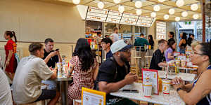 The covered courtyard is reminiscent of a 1950s Californian drive-in or a 1980s McDonald's.