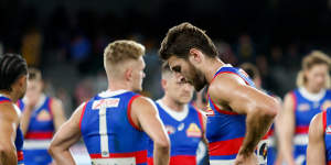 Marcus Bontempelli and Adam Treloar look dejected after the Bulldogs’ shock loss to the Hawks.