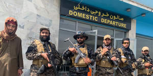 Taliban fighters stand guard inside the Hamid Karzai International Airport the day after US forces departed. 
