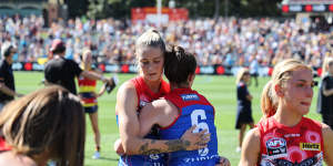 Tayla Harris and Daisy Pearce of the Demons react during the 2022 AFLW Grand Final match between the Adelaide Crows and the Melbourne Demons at Adelaide Oval on April 09,2022.
