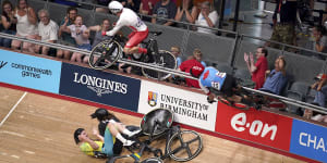 English cyclist Mall Walls (left) and Canadian Derek Gee crash in to the crowd during the men’s 15km scratch race qualifying round.