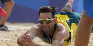 Damian Schumann,of Australia,dives for the ball during a men’s beach volleyball match against the ROC team on Monday.