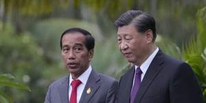 Widodo walks with Chinese President Xi Jinping in Bali,where they met on the sidelines of the G20 summit in November.