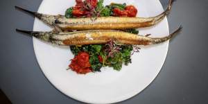 Grilled garfish with charred kale and braised cherry tomatoes.
