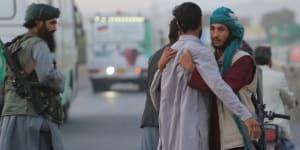 A Taliban soldier frisks someone at a checkpoint in Herat. 