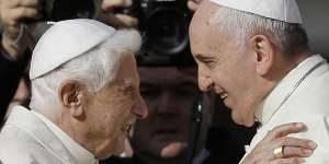 Pope Francis (right) and Pope Emeritus Benedict XVI embrace in 2014.