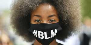A protestor wearing a face mask to protect against coronavirus,takes part in a Black Lives Matter protest rally in the UK.