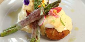 Eggs benedict with jamon-wrapped asparagus spears.