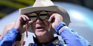 Jeff Bezos,founder of Amazon and space tourism company Blue Origin,puts goggles over his eyes that belonged to aviator Amelia Mary Earhart during a post launch news briefing from its spaceport near Van Horn,Texas.