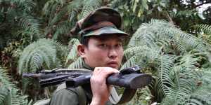 A Kachin Independence Army fighter walks along a jungle path in northern Kachin state,Myanmar.
